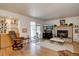 Bright living room features wood floors, a fireplace, and a wet bar offering an inviting space for relaxation and entertainment at 7160 S Jellison St, Littleton, CO 80128