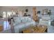 Comfortable living room with plush seating, natural light, and seamless flow to the dining area at 7160 S Jellison St, Littleton, CO 80128
