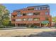 Brick building exterior with parking and landscaping at 624 Pearl St # 301, Boulder, CO 80302