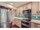 Modern kitchen with stainless steel appliances and island at 624 Pearl St # 301, Boulder, CO 80302