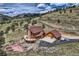 An aerial view captures a log home with a three-car garage on a vast, treed lot at 401 Raptor Point Rd, Golden, CO 80403