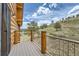Scenic view from a wooden balcony with metal railings, offering picturesque hillside views at 401 Raptor Point Rd, Golden, CO 80403