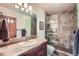 Bathroom featuring a glass-enclosed shower with tile surround, toilet, and vanity with sink at 401 Raptor Point Rd, Golden, CO 80403