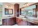 Bathroom with dual sinks, marble countertops, custom cabinets, and mountain view at 401 Raptor Point Rd, Golden, CO 80403