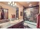 Bathroom featuring tiled vanity, glass shower door, and modern fixtures at 401 Raptor Point Rd, Golden, CO 80403