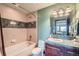 Bathroom featuring a built-in tub, a marble countertop sink, and stylish fixtures at 401 Raptor Point Rd, Golden, CO 80403