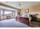 Bedroom with a bay window, a dark wood bed frame, a ceiling fan, and wall-to-wall carpeting at 401 Raptor Point Rd, Golden, CO 80403