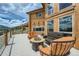 Inviting outdoor deck with cozy seating, a fire pit, and picturesque views, ideal for enjoying the serene surroundings at 401 Raptor Point Rd, Golden, CO 80403