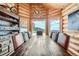 Elegant dining room with rustic wood table, antler chandelier, built-in shelving and scenic mountain views at 401 Raptor Point Rd, Golden, CO 80403