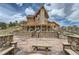 Striking log home with a stone facade, large deck, and stone benches, perfect for outdoor relaxation and entertaining at 401 Raptor Point Rd, Golden, CO 80403