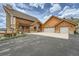 A charming log home with a stone facade and three-car garage exudes rustic elegance at 401 Raptor Point Rd, Golden, CO 80403