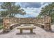 A stone fire pit area with built-in seating provides an inviting outdoor retreat at 401 Raptor Point Rd, Golden, CO 80403