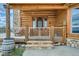 Charming log home entrance with a wooden door, stone steps, and rustic details, creating a welcoming curb appeal at 401 Raptor Point Rd, Golden, CO 80403