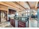 Spacious kitchen with granite countertops, stainless steel appliances, and log beam ceiling at 401 Raptor Point Rd, Golden, CO 80403