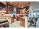 Charming kitchenette featuring rich cabinetry, granite counters, a unique ceiling, and bar seating at 401 Raptor Point Rd, Golden, CO 80403