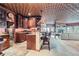 Charming kitchenette featuring rich cabinetry, granite counters, a unique ceiling, and bar seating at 401 Raptor Point Rd, Golden, CO 80403