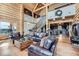 Spacious living room with log walls, hardwood floors, and comfortable leather furniture, perfect for relaxation at 401 Raptor Point Rd, Golden, CO 80403