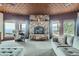Inviting living room boasts a stone fireplace, plush seating, and scenic mountain views from large windows at 401 Raptor Point Rd, Golden, CO 80403