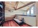 Cozy loft area with wood floors, a comfortable futon, and natural light from the view outside at 401 Raptor Point Rd, Golden, CO 80403