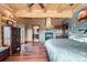 Main bedroom with stone fireplace, hardwood floors, walk-in closet, and ensuite bath at 401 Raptor Point Rd, Golden, CO 80403