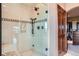 Tiled shower featuring glass door, shower seat, and mountain views through the window at 401 Raptor Point Rd, Golden, CO 80403