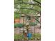 Charming backyard stone patio with garden, mature tree, and water feature at 2201 Cherry St, Denver, CO 80207