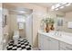 Bathroom featuring black and white tile floors and a bright vanity at 2201 Cherry St, Denver, CO 80207