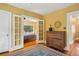 Bedroom view through French doors, showing hardwood floors and stylish furniture at 2201 Cherry St, Denver, CO 80207
