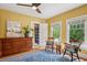Bright bedroom featuring hardwood floors, large windows, and vintage-style furniture at 2201 Cherry St, Denver, CO 80207