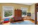 Bedroom with hardwood floors, built-in storage, and natural light from two windows at 2201 Cherry St, Denver, CO 80207