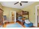 Bedroom featuring a wooden bunk bed, hardwood floors, and attached bathroom at 2201 Cherry St, Denver, CO 80207