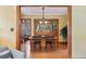 Dining room featuring hardwood floors, a wooden table, a decorative hutch, and views into other rooms at 2201 Cherry St, Denver, CO 80207