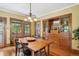 Traditional dining room with hardwood floors, built-in hutch, and updated lighting fixture above a natural wood table at 2201 Cherry St, Denver, CO 80207
