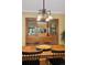 Dining room with a wooden hutch, an elegant light fixture, and a wooden table with seating at 2201 Cherry St, Denver, CO 80207