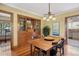 Bright dining room featuring hardwood floors, a built-in hutch, and a modern light fixture over the wooden table at 2201 Cherry St, Denver, CO 80207