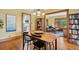 Dining room with wood floors, a classic table and views to the kitchen and living room in an open concept home at 2201 Cherry St, Denver, CO 80207