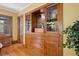 Dining area featuring a built-in hutch, hardwood floors, and detailed trim around the windows and doors at 2201 Cherry St, Denver, CO 80207