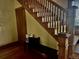 Welcoming entryway with wooden staircase, hardwood floors, and a bench perfect for taking off shoes at 2201 Cherry St, Denver, CO 80207