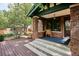 Charming front porch with brick pillars and cozy seating, perfect for relaxing at 2201 Cherry St, Denver, CO 80207