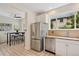 Kitchen featuring stainless steel appliances and stone countertops, that opens to a breakfast nook with view of back yard at 2201 Cherry St, Denver, CO 80207