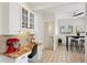 Open kitchen layout with stone countertops, white cabinets, breakfast nook, and access to the lower level at 2201 Cherry St, Denver, CO 80207