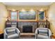 Living room featuring a fireplace with tile surround, built-in bookshelves, and comfortable seating at 2201 Cherry St, Denver, CO 80207