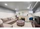 Finished basement with a comfortable living area, brick fireplace, and recessed lighting at 2201 Cherry St, Denver, CO 80207