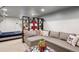 Cozy living room features a sectional sofa, open shelving, and neutral decor at 2201 Cherry St, Denver, CO 80207