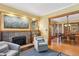 View of the living room featuring a fireplace, an adjacent dining room, and hardwood floors at 2201 Cherry St, Denver, CO 80207