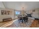 Elegant dining room featuring a cozy fireplace, modern chandelier, and seating for six at 18263 E Mansfield Ave, Aurora, CO 80013