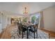 Elegant dining room featuring a table seating six, leading to the kitchen at 18263 E Mansfield Ave, Aurora, CO 80013