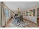 Elegant dining room featuring a cozy fireplace, modern chandelier, and seating for six at 18263 E Mansfield Ave, Aurora, CO 80013