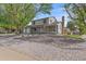 Charming two-story home with a well-maintained lawn, mature trees, and a two-car garage at 18263 E Mansfield Ave, Aurora, CO 80013