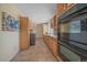 View of the kitchen featuring tile floors, stainless steel oven, and adjoining laundry room at 18263 E Mansfield Ave, Aurora, CO 80013